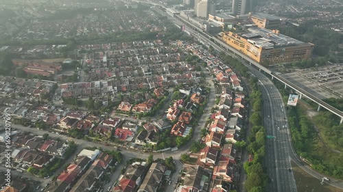 Aerial View of a Lively Urban Highway with Scenic Neighborhoods under Morning Light in July
