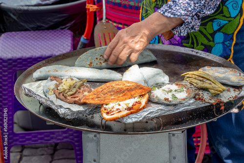Quesadillas, Pambazos, Tlacoyos in a comal, Mexican food.