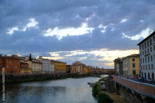Florence, Italy – view of the Arno River with historic buildings along the riverside and Renaissance architecture reflecting in the water.