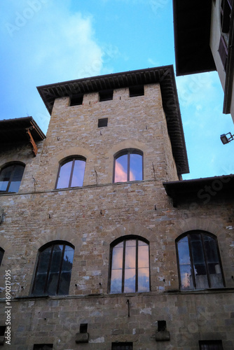 Florence, Italy – narrow cobblestone street in the historic center with rustic buildings and traditional Italian architecture.