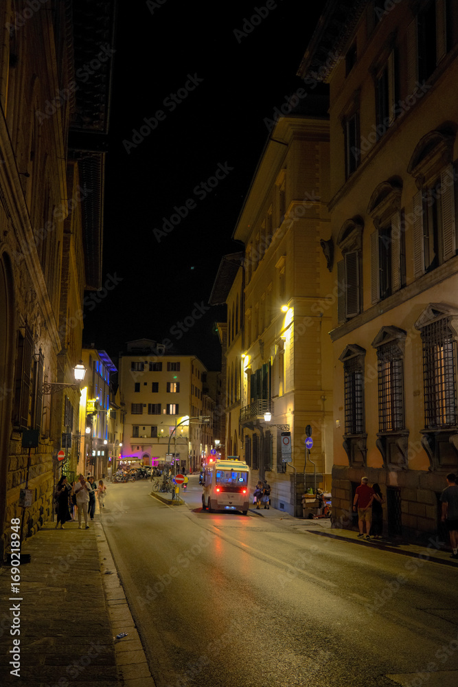 Naklejka premium Florence, Italy at night with illuminated cathedral, Arno River reflections, and historic city skyline.