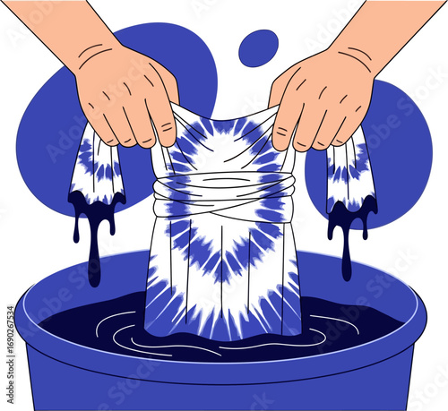 Tiedye process Hands dyeing a tshirt in a blue dye bath