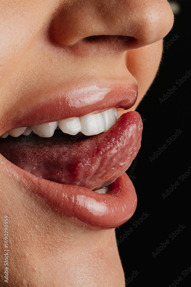 Fototapeta premium Close-Up of Woman’s Mouth with Tongue Out