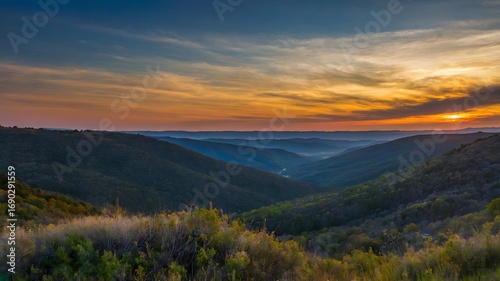 Majestic Sunset over Rolling Hills and Mountains A Breathtaking Panorama