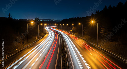 Long exposure captures the dynamic flow of traffic on a dark highway.

