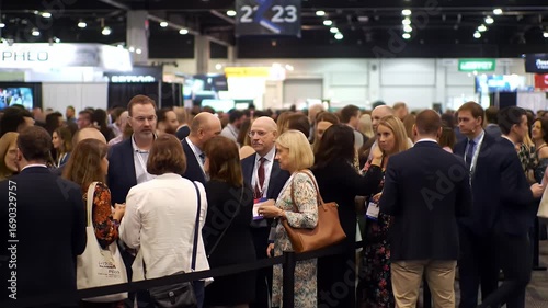 Busy Conference Hall Filled with People in Professional Attire Blurred Background