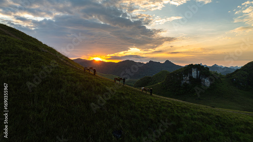 Fotografija Dawn on the high mountain peaks of Ha Lang area, with pack horses and people going to work