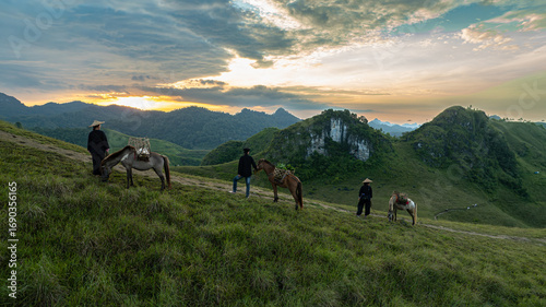 Fotografija Dawn on the high mountain peaks of Ha Lang area, with pack horses and people going to work