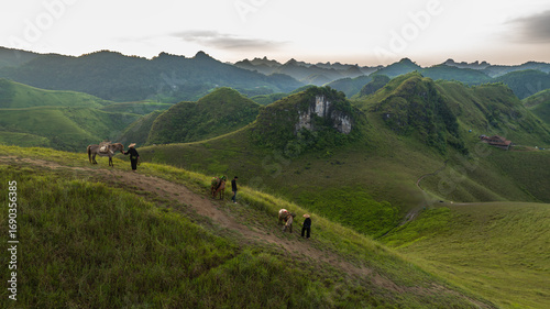 Slika na platnu Dawn on the high mountain peaks of Ha Lang area, with pack horses and people going to work