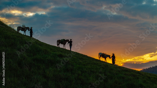 фотографія Dawn on the high mountain peaks of Ha Lang area, with pack horses and people going to work