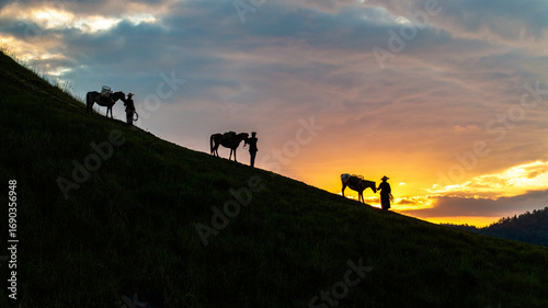 Fotografija Dawn on the high mountain peaks of Ha Lang area, with pack horses and people going to work