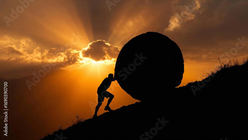 A dramatic silhouette of a person pushing a huge round boulder uphill on a rocky mountain slope at sunset