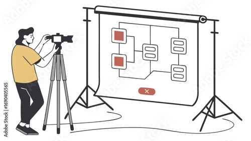 Photographer filming a flowchart on a backdrop using a camera on a tripod.