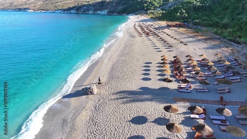 Albania Ionian coast Krorëza beach beautiful emerald crystal water, beach umbrella straw