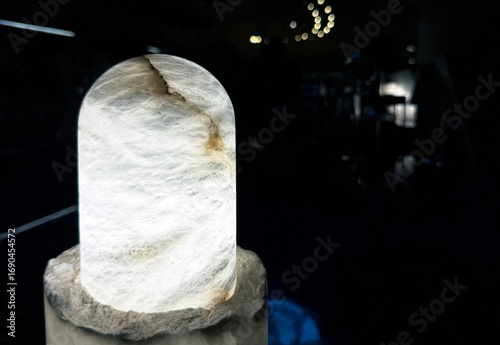 Natural solid stone table lamp in dark light background.