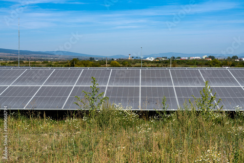 Photovoltaic solar panel park near a small city in Romania.