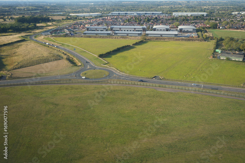 East Midlands Airport, England - September 5 2025: Aerial view of countryside road and fields near airport perimeter.