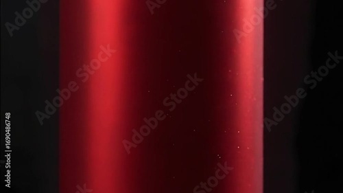 Closeup of Red Metallic Surface with Water Droplets in Slow Motion