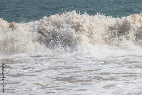 The ocean is rough and the waves are high
