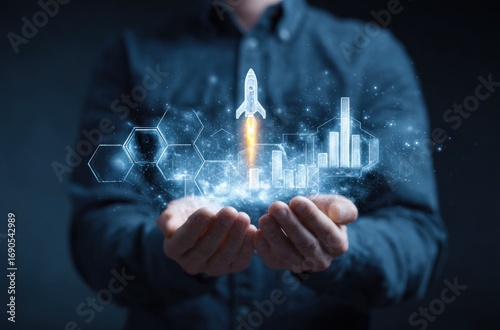 Man in a blue shirt holds glowing digital icons a rocket launch, bar graphs, and a honeycomb grid, all shimmering above his hands, against a dark background