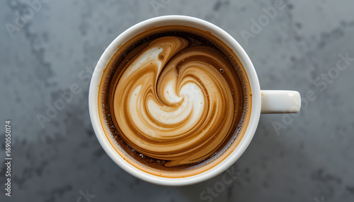 A top-down view of a cream swirled coffee cup, featuring a rich, 