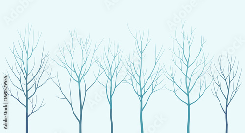 Minimalist winter trees silhouetted against a pale blue sky with delicate branches reaching upwards