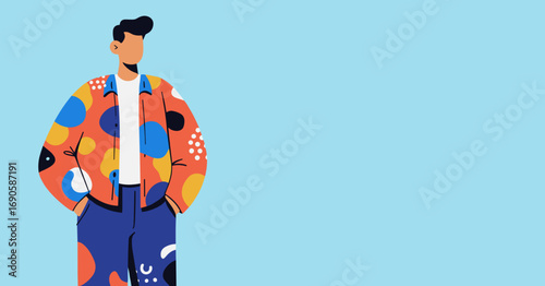 A stylish man in a vibrant, patterned jacket stands confidently with hands in pockets against a clean, light blue background, showcasing modern fashion trends.