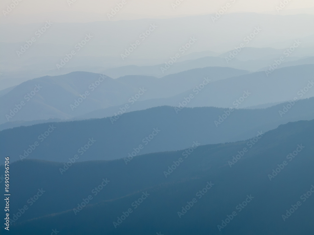 Fototapeta premium Hazy mountain ranges at dawn