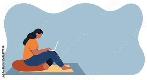 Young woman working remotely on laptop from home, sitting comfortably on a cushion. Ideal for concepts of productivity, digital nomad, or online learning.