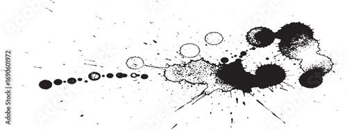 Black ink splatters and drops forming abstract dynamic black and white artistic composition