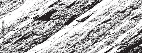 Closeup of rough textured rock surface with deep crevices forming dramatic black and white natural pattern