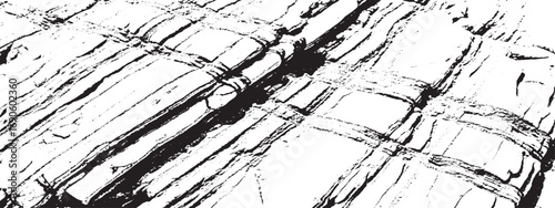 Black and white texture of cracked rock layers showcasing rugged natural geological patterns
