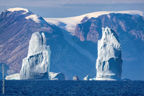 Tablou pe pânză A pair of blue towering icebergs appear to form gates in Ofjord, or O fjord, Scoresby Sund, Greenland