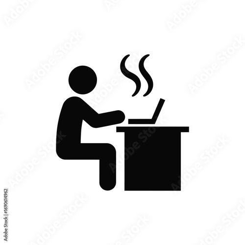 Person working on a laptop computer at a desk