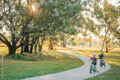 Children riding bikes along walking track in natural Australian bush setting