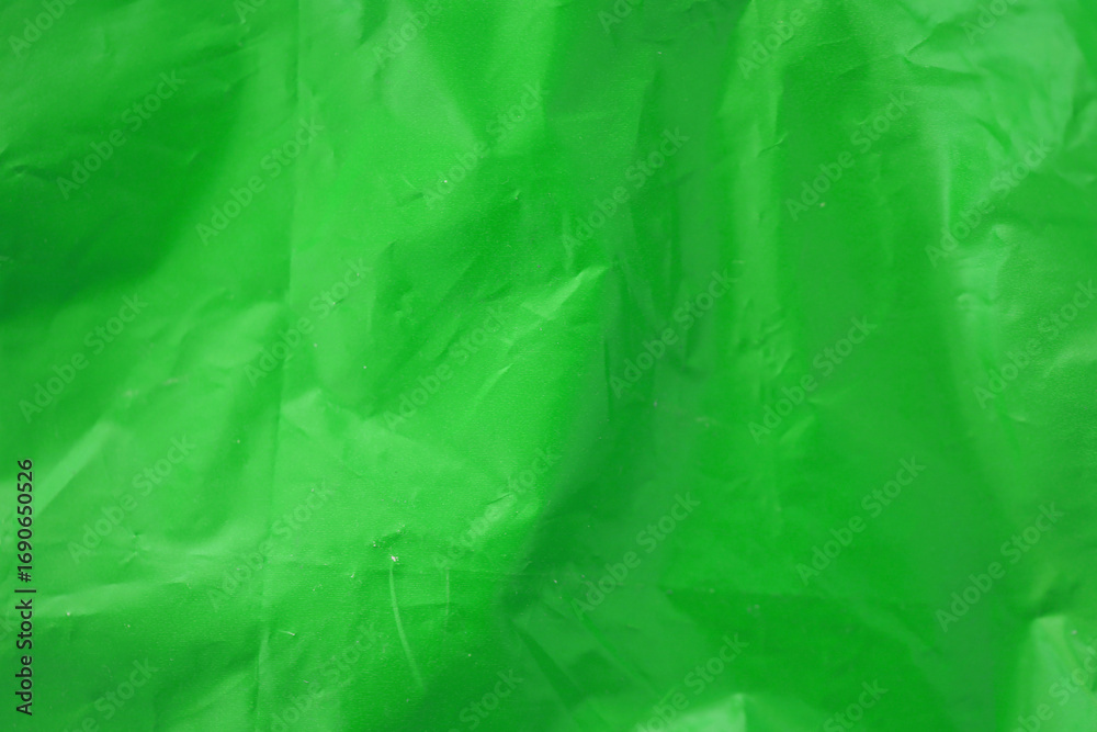 Fototapeta premium Texture of Green color plastic bag smooth crumpled surface