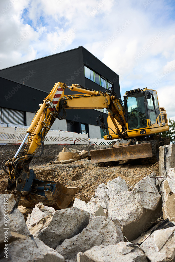 Obraz premium Road repair in urban environment. Repair with large equipment. Repair barriers. Demolition. Excavator work.