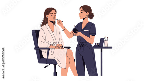 Professional makeup artist applying foundation to a woman sitting in a chair wearing a white robe in a studio setting