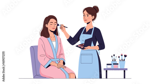 Professional makeup artist applying blush to a seated woman s face with a brush and palette in a salon setting