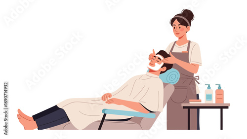 Skilled beautician applying a facial mask to a relaxed man lying on a chair in a clean modern salon