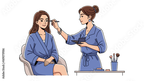 Professional makeup artist applying cosmetics to a young woman in a blue robe for a beauty session