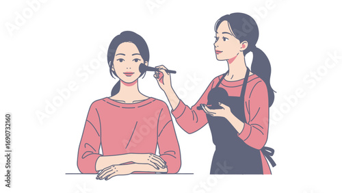 Young woman applying makeup to another woman s face with a brush in a beauty salon or studio setting