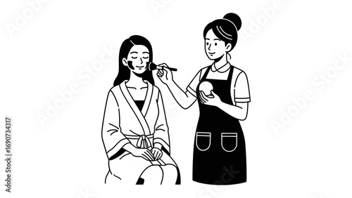 Professional makeup artist applying foundation to a young woman s face with a brush in a salon or studio setting