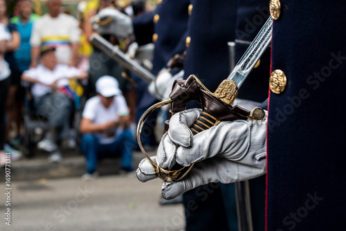 Soldier holding command saber, Military with ceremonial sword, Armed forces with symbol of authority. High quality photo
