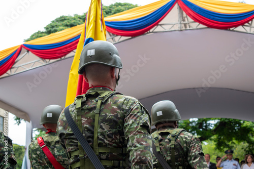Soldiers with Colombian flag in background, Colombian military in formation, Armed forces with national patriotic symbol. High quality photo