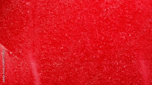 Drops of condensation on the red ice cream tank. Ice cold sorbet machine mixing fruit juice. 