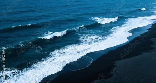 Aerial View of Waves Crashing on a Black Sand Beach and Coastline, Natural Scenery Background