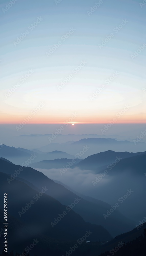 Fototapeta premium Mesmerizing Mountain Landscape with Layers of Misty Valleys Under a Tranquil Sunrise Sky Creating a Breathtaking Horizon View