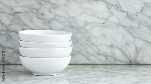 Four white bowls stacked on top of each other.