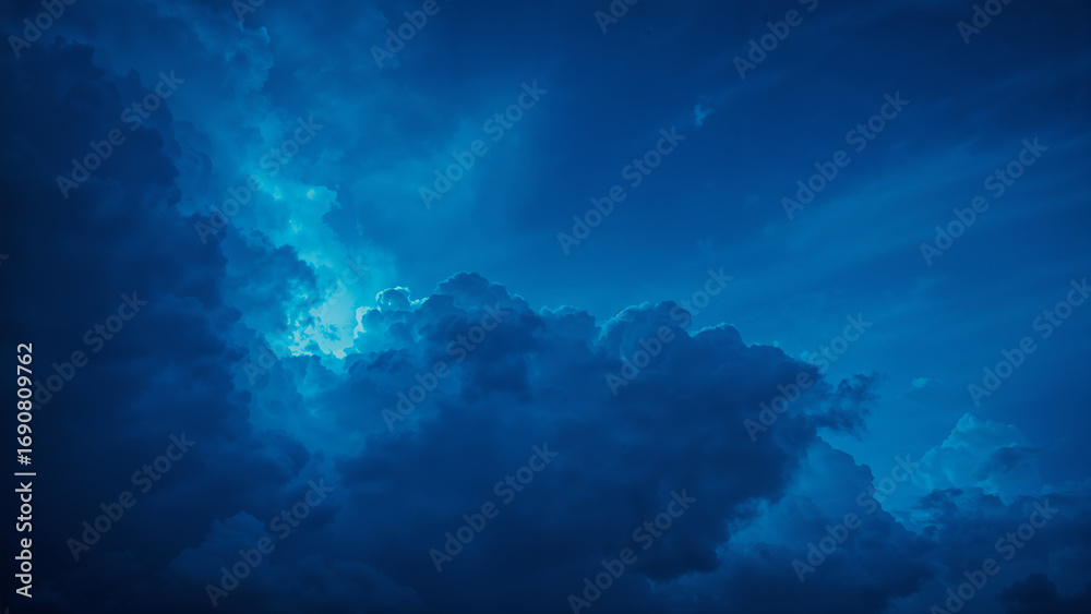 Fototapeta premium Vibrant Blue Clouds with Soft Light Radiating Through